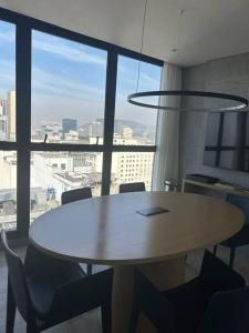 a table and chairs in a room with a large window at 2701 Studio Skylux - Centro - Rio de Janeiro in Rio de Janeiro +22 photos