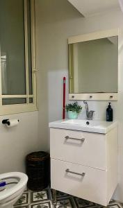 a bathroom with a sink and a mirror and a toilet at כמו חדר במלון מרפסת חניה פרטית in Tel Aviv +10 photos