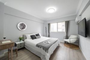 Postel nebo postele na pokoji v ubytování 上海柠檬汁民宿 Shanghai lemon juic B&B -Shanghai Lemon Deluxe Room外滩南京东路步行街
