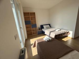 a small bedroom with two beds and a window at Maranello 6 chilometri - Casa Ferrari 2 bedrooms Parcheggio Privato in Montale
