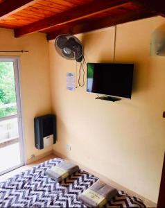 a room with a flat screen tv on the wall at Costa Clara Hotel in Santa Clara del Mar