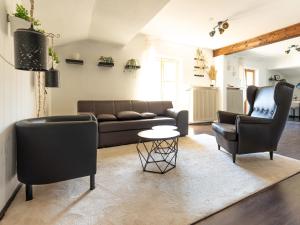 a living room with a couch and two chairs at Relax Appartment Walchensee in Walchensee