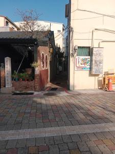 an empty street with a building and a sidewalk at Chongguang Hotel in Tainan +13 photos