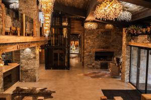 a large room with brick walls and chandeliers at Brentas Spa Resort in Tsigov Chark