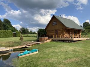 a log cabin with a boat in front of it at Tatra Holiday House in Tatra +8 photos