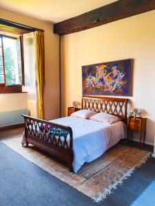PlouguielにあるLe domaine de Kerousyのベッドと壁に絵が飾られた寝室