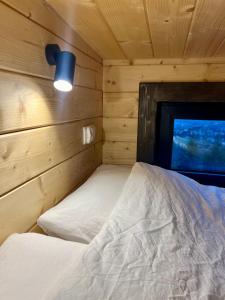 a bedroom with a bed in a wooden cabin at Flow Hill in Kościelisko