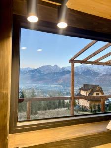 a window with a view of a mountain view at Flow Hill in Kościelisko +29 photos