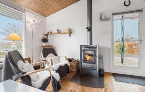 a living room with a wood burning stove at 3 Bedroom Nice Home In Roslev in Roslev