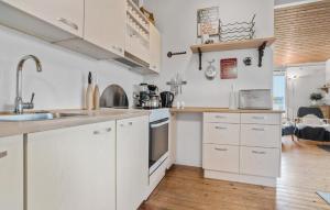 a kitchen with white cabinets and a sink at 3 Bedroom Nice Home In Roslev in Roslev