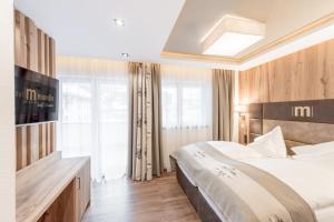 Ένα ή περισσότερα κρεβάτια σε δωμάτιο στο Hotel Mondin
