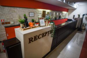a reception counter in a restaurant with plants on it at Hotel Elyon Dej in Dej