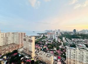 an aerial view of a city with tall buildings at 2 bed room 5 queen bed luxury sea view apartment in Jelutong