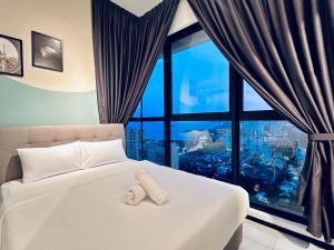 a bedroom with a white bed with a large window at 2 bed room 5 queen bed luxury sea view apartment in Jelutong