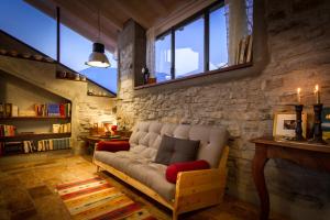 a living room with a couch and a window at Le Casette Apartments - byMyHomeinComo in Blevio