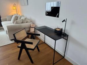 a living room with a table and a chair and a couch at Holzapfelpalais in Bad Mergentheim