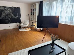 a living room with a large flat screen tv at Holzapfelpalais in Bad Mergentheim