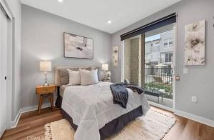 a bedroom with a bed and a large window at 1311WCara in Anaheim +16 photos