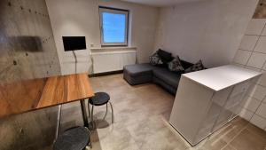 a living room with a couch and a table at Gästezimmer 1 Heiterwanger-Blick in Heiterwang
