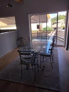 a dining room with a glass table and chairs at Julie in Saint-Bonnet-sur-Gironde +20 photos