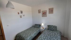 a bedroom with two beds and a lamp in it at Sunnydays in Roldán +23 photos
