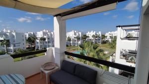 a balcony with a couch and a view of a city at Sunnydays in Roldán