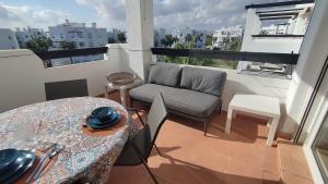a living room with a couch and a table and a tableablish at Sunnydays in Roldán