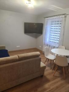 a living room with a couch and a table at Apartament mieszkanie do wynajęcia Justyna in Walim
