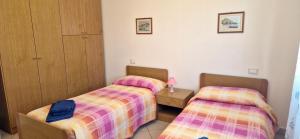 two twin beds in a room with at Viareggio all seasons in Viareggio