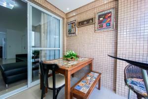 einen kleinen Tisch in einem Zimmer mit einer gefliesten Wand in der Unterkunft LINDO APARTAMENTO NOVO PARA 6 PESSOAS EM PALMAS. in Governador Celso Ramos