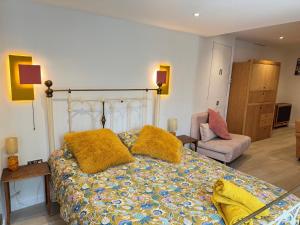 a bedroom with a bed with yellow pillows on it at Keeley House in Exeter