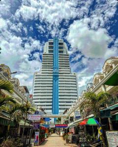 a tall building with a street in front of it at Patong Tower Apartment - AMP in Patong Beach