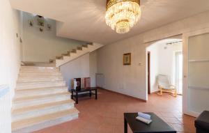 a staircase in a living room with a chandelier at Lovely Home In Castiglione Del Lago in Castiglione del Lago