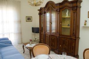 a living room with a large wooden cabinet at Summer apartment in Viareggio