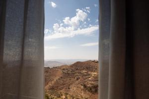 a view of a canyon from a window at La Casa dei Mori in Centuripe