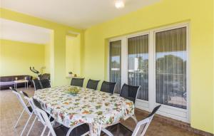 a dining room with a table and chairs at Nice Apartment In Stinjan in Štinjan +18 photos