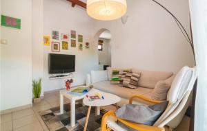 a living room with a couch and a table at Cozy Home In Vrbanj With Sauna in Basina