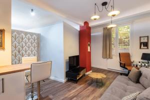 a living room with a couch and a table at couple-inn 2 Quality hot tab suite in Thessaloniki