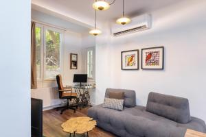 a living room with a couch and a table at couple-inn 2 Quality hot tab suite in Thessaloniki