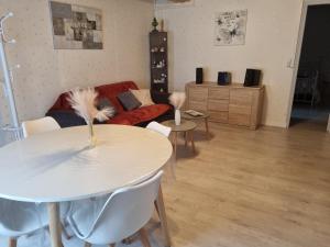 a living room with a table and a couch at appartement centre ville in Salbris