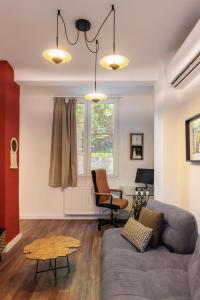 a living room with a couch and a table at couple-inn 2 Quality hot tab suite in Thessaloniki