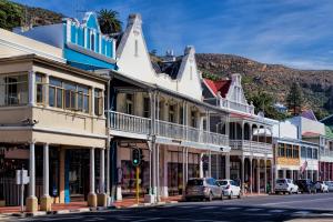 a street in a town with cars parked at Eccentric Heritage Paradise Simon's Town in Simonʼs Town