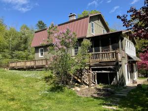 a large wooden house with a red roof at Hawkeyes Rest in Johnsburg