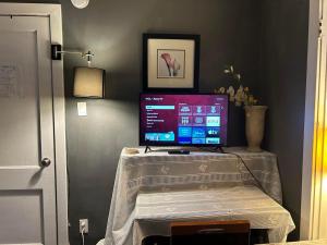 a computer monitor sitting on a table in a room at Maryland Homestay in Winnpeg downtown in Winnipeg
