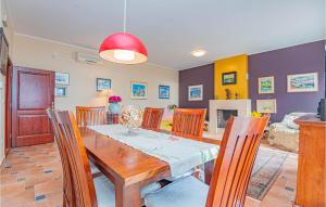 a dining room and living room with a table and chairs at Awesome Home In Zaboric With Wifi in Zaboric