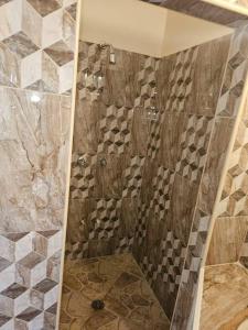 a shower with a glass door in a bathroom at Jardin Damon in Soufrière +50 photos