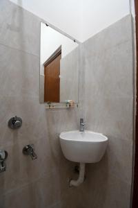 a bathroom with a sink and a mirror at Bonobitaan Hotel & Restaurant in Srī Niketan +31 photos