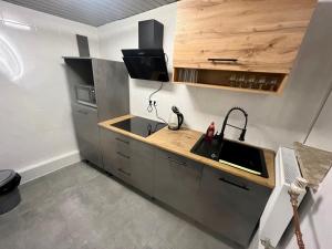 a kitchen with a sink and a counter at Gemütliches Ferienhäuschen in Neumünster