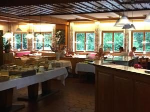 a restaurant with tables and people sitting at tables at Hotel-Restaurant Buger Hof in Bamberg