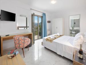 a bedroom with a bed and a desk and a chair at Villa in Corfu with Stunning Mountain Views in Kanakádes